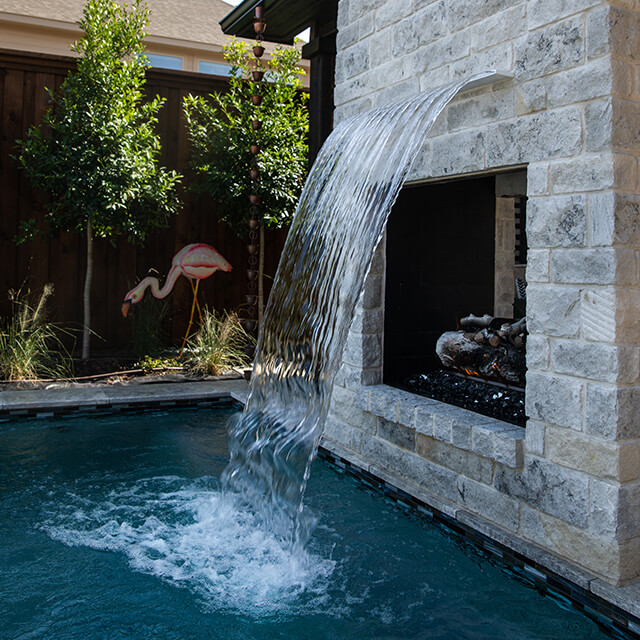 a pool and arbor at night
