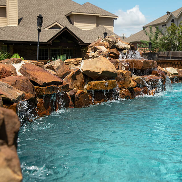 a pool and arbor at night