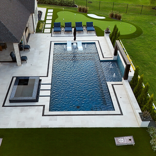 bmrpoolandpatio22 a pool and arbor at night