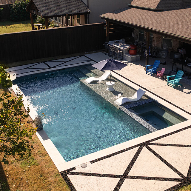 bmrpoolandpatio30 a pool and arbor at night