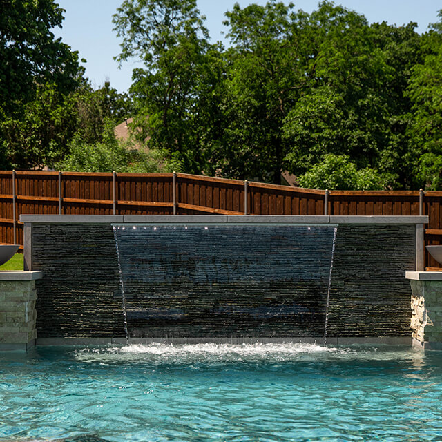 a pool and arbor at night