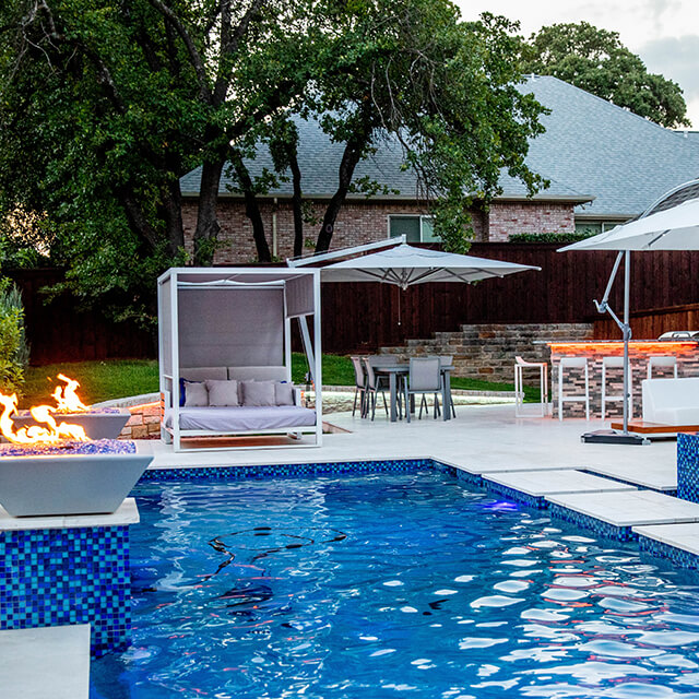 bmrpoolandpatio4 a pool and arbor at night