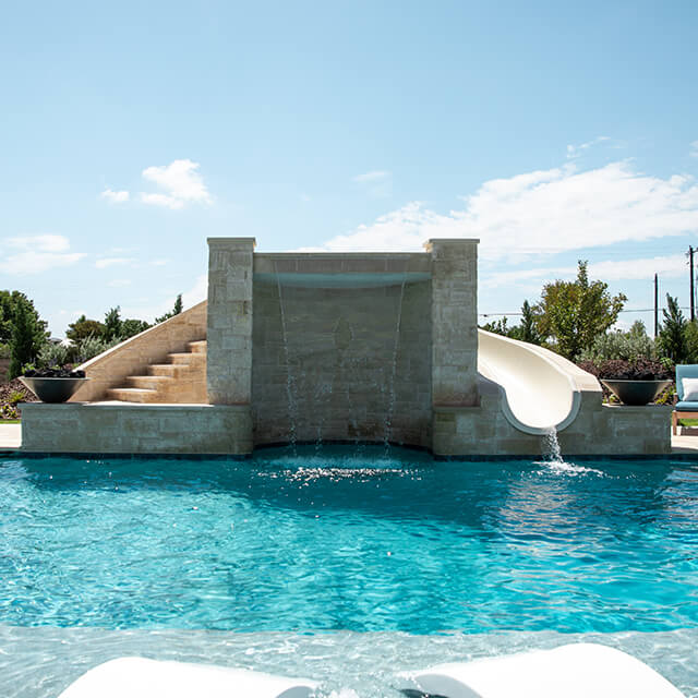 a pool and arbor at night