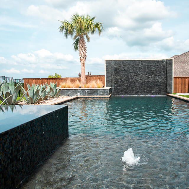 a pool and arbor at night