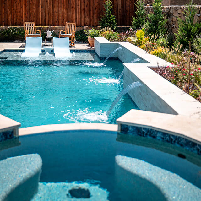 a pool and arbor at night