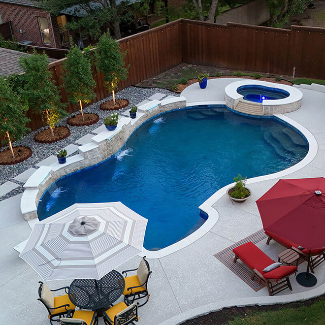 a pool and arbor at night