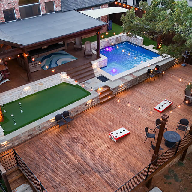 a pool and arbor at night
