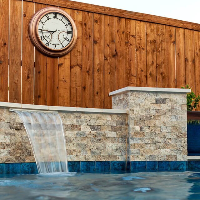 a pool and arbor at night